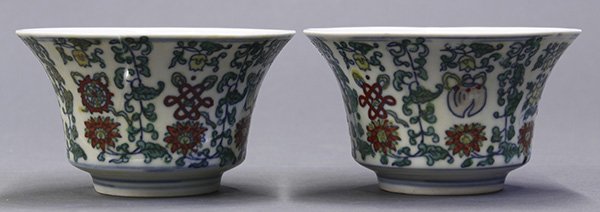 Chinese Doucai Porcelain Cups, Buddhist Symbols: (lot of 2) Chinese doucai porcelain cups, each of inverted flared bell form, decorated with Eight Buddhist Symbols amid tendrils, the base with an apocryphal Chenghua mark (one repaired), 4"h