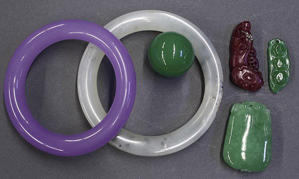 Six Chinese Hardstone Bangles and Carvings: (lot of 6) Chinese hardstone toggles and bangles, consisting of a green spherical bead; a melon form toggle; one of peapod shape; a red ruyi scepter with a bat; a lavender bangle; and a frosted white