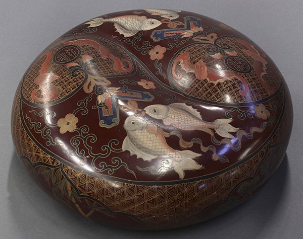 Chinese Lacquer Circular Box: Chinese polychromed lacquer circular box, the lid with a molded taiji emblem with a pair of bats within a peach form reserve above a chime and pair of fish, the side of the box with pine and prunus, 1