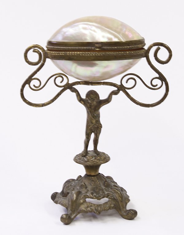 Neoclassical style partial gilt shell box: Neoclassical style partial gilt shell box, the hinged iridescent shell surmounting the patinated stand, having a figural putti standard holding up tendrils that become the handles, the whole resting o