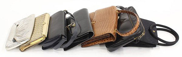 Vintage Gucci purses: (lot of 7) Vintage Gucci purses including a woven gold lame clutch; together with a Hermes black leather gentleman's travel bag; plus a Brunettini leather silver lame evening clutch. Provenance: Prope