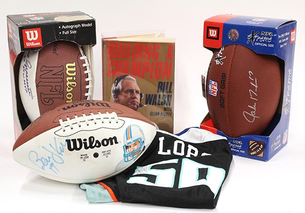 NFL autographed footballs: (lot of 5) NFL autographed footballs signed by former players; Berrnie Kosar, Jake Delhomme, and Gino Cappelletti; together with an autographed book Building A Champion by Bill Walsh; and an autograph
