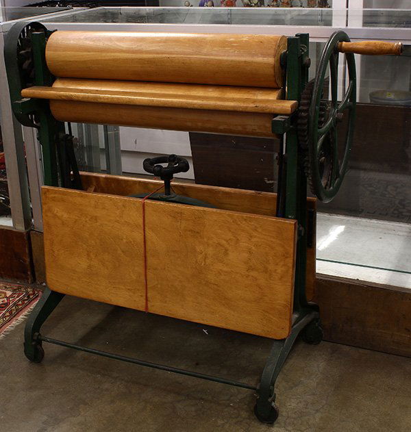 Swedish dry linen press (mangle): Swedish dry linen press (mangle), the hand crank operating the double roller system above the twin fold out panels, frame retains the original green paint, and marked Norrahammars Bruk, 4011, 38"h x 4