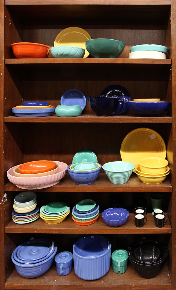 Six shelves of Garden City pottery table accessories: (lot of approx 73) Six shelves of Garden City pottery table accessories and jardineres, including a green ringed vase, (3) sets of graduated bowls, an orange tea pot, a pink low bowl, ringed bowls in