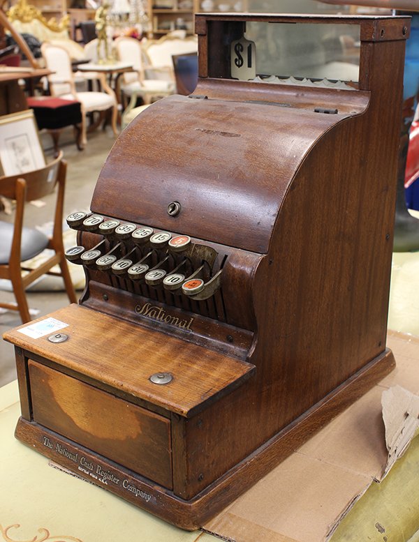 Candy shop cash register style number 711: Candy shop cash register style number 711, circa 1901, by the National Cash Register Company, executed in faux wood grain on metal, 17"h x 9"w x 16"d. Provenance: The Jeff Sahadi collection