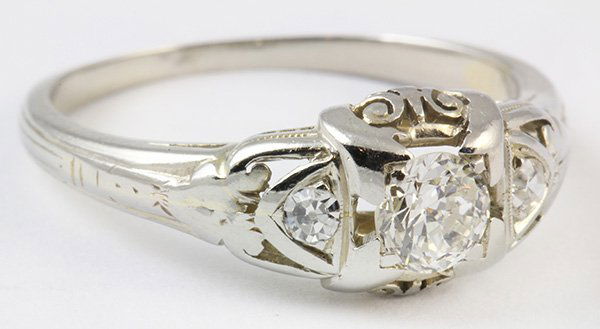 Art Deco diamond white gold ring: Art Deco diamond and 18K white gold ring featuring (1) old European cut diamond weighing approximately 0.27 ct., accented by (2) single cut diamonds totaling approximately 0.04 ct., set in an 18K whit
