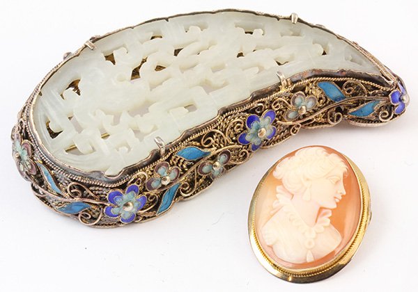 Collection of brooches: (Lot of 2) Brooches including one pierced and carved serpentine plaque set in a silver gilt brooch decorated by enamel, 3 X 1 1/2 inches, 31 grams; together with one shell cameo depicting the profile 