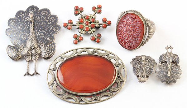 Collection of mostly carnelian and silver jewelry: Collection of gemstone and silver jewelry including a carved carnelian and silver ring; A Niello silver peacock brooch and a pair of matching clip earrings; A large carnelian and silver brooch, togeth
