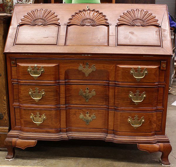 Chippendale style block and slant front desk: Chippendale style block and slant front desk, executed in rosewood with three shells carved into the drop front, above a stylized block front case with three drawers all having cock beading, and the w