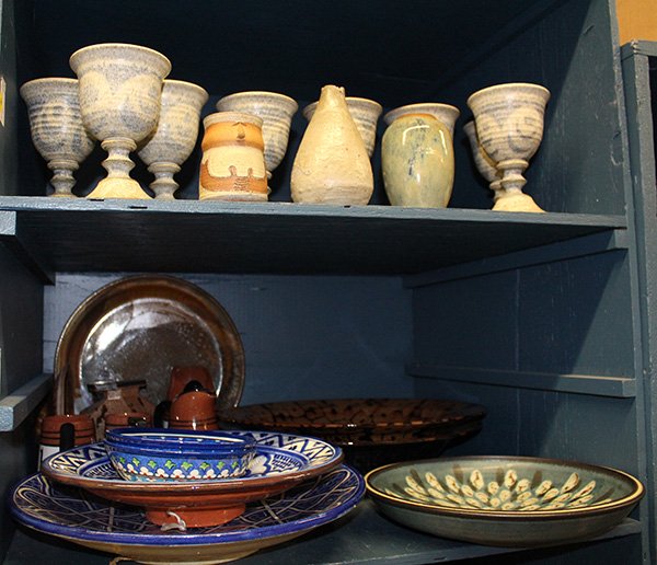 Two bins of art pottery including goblets with mottled: Two bins of art pottery including goblets with mottled cream and grey glaze, vases, and large serving platters together with Moroccan pottery and a Peruvian tea set