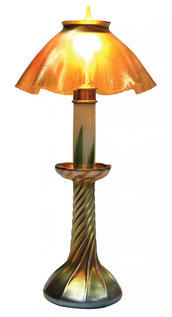 Tiffany Studios: Tiffany Studios, New York, three piece candle lamp, having a favrile glass shade, signed "L.C.T." above the glass insert with green feathered accents, rising on a spiral ribbed lamp base, marked "L.C.