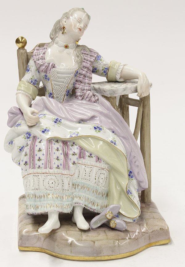Meissen porcelain figural group: Meissen porcelain figural group, depicting a beauty at rest, having kicked off her shoes, she sinks into a chair with one arm draped over a side table, she wears a bow in her hair, a lace collar, and 