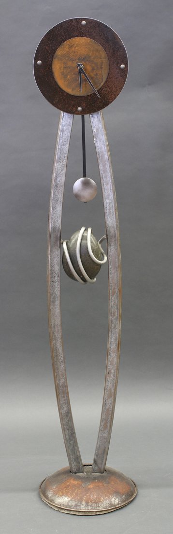 Moderne Rudolf Calkovsky (Californian) iron sculptural: Moderne Rudolf Calkovsky (Californian) iron sculptural floor standing clock, signed "R. Calkovsky / Original", the patinated dial above the silvered standard with pedulum, and rising on a circular bas