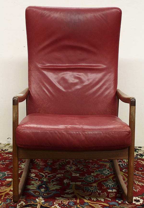 Danish Modern teak rocking lounge chair: Danish Modern teak rocking lounge chair, having red leather cushions centering the curved sculptural arms continuing to the square rockers, 40"h x 22" w x 21"d