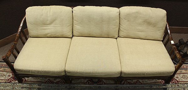 McGuire, San Francisco, rattan sofa, having six loose: McGuire, San Francisco, rattan sofa, having six loose cushions centering the rattan frame having a contoured back continuing to the down sloped arms, and rising on outswept legs, 31"h x 75"w x 32"d