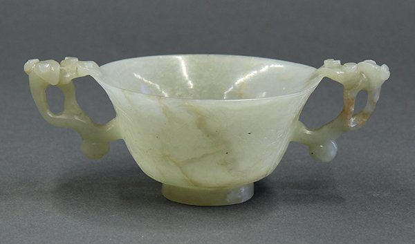 Chinese Jade Cup, Flower, Ming/Qing: Chinese celadon jade cup, late Ming/Qing dynasty, of inverted bell form incised with the Three Friends of Winter (pine, bamboo and prunus), flanked by lingzhi form handles and raised on a splayed foot