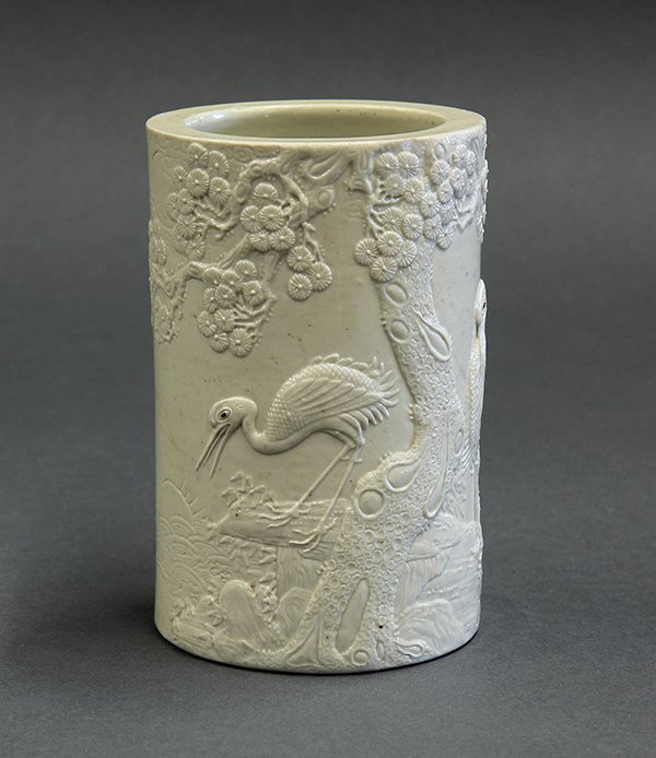 Chinese Porcelain Brush Pot, Cranes, Wang Bingrong Mark: Chinese molded porcelain brush pot, the cylindrical exterior featuring a pair of cranes standing below a gnarled pine tree, the recessed base marked 'Wang Bingrong zuo' (rim chip), 5.5"h