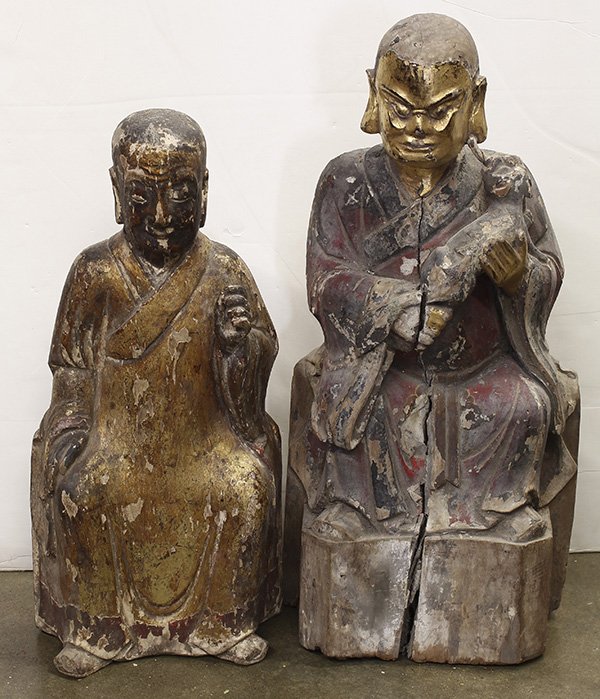 Two Chinese Gilt Wood Figures: (lot of 2) Chinese gilt lacquered wooden Buddhist carvings, one of a gilt face luohan carrying a lion; together with seated monk with his left fist raised, 16.5"h and 19"h