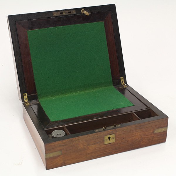 Victorian field writting desk: Victorian field writting desk, 19th century, executed in rosewood, the front having a brass inlaid escutcheon, the rectangular lid opening to a fitted interior with felt writing surface, 4"h x 12"w x 