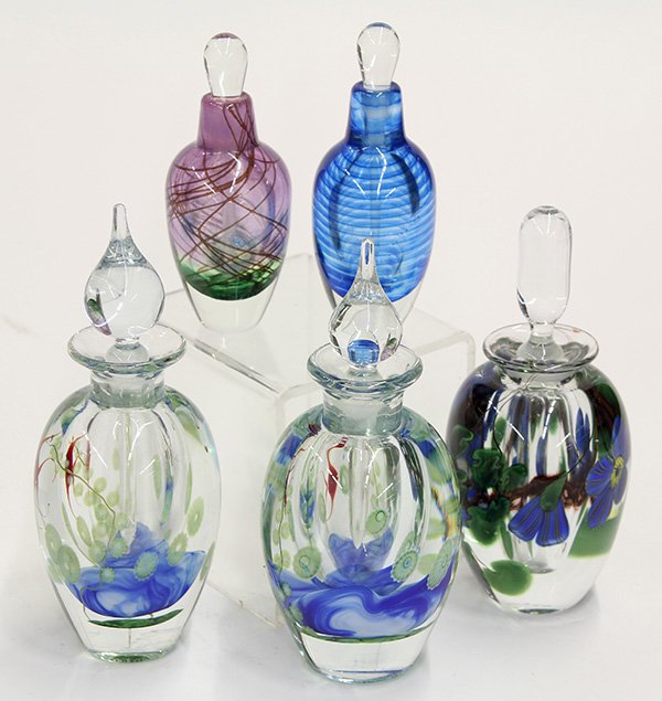 Art glass stoppered perfume bottles: (lot of 5) Art glass stoppered perfume bottles, consisting of two Lundberg Studios aquarium examples, each having a tear drop stopper and depicting tropical fish amongst sea gass and shells, signed "L