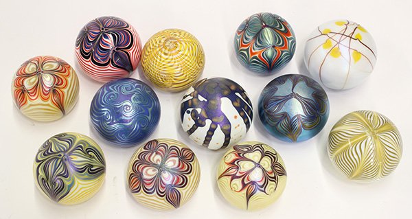 Smyers Glass paperweights: (lot of 12) Smyers Glass paperweights most having a pulled feather pattern; together with two Northern Star paperweights one signed by C. Buzzini