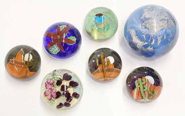 Lundberg Studios art glass paperweights: (lot of 7) Lundberg Studios art glass paperweights including three signed by Steven Lundberg depicting desert nights; three floral examples signed by Daniel Salazar; together with a James Lundberg Wor