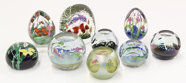 Lundberg Studios cased floral art glass paperweights: (lot of 9) Lundberg Studios cased floral art glass paperweights including egg form and faceted examples, three signed S. Lundberg; together with a signed Daniel Salazar cased paperweight showing a yel