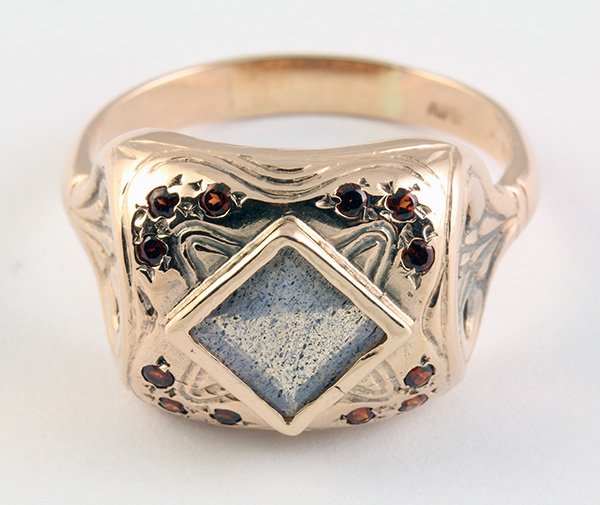 Labradorite, garnet and rose gold ring: Labradorite, garnet and 14k rose gold ring bezel set with one square faceted labradorite measuring approximately 7.3 x 7.3 mm, accented by twelve small round cut garnets set in a scroll design mountin