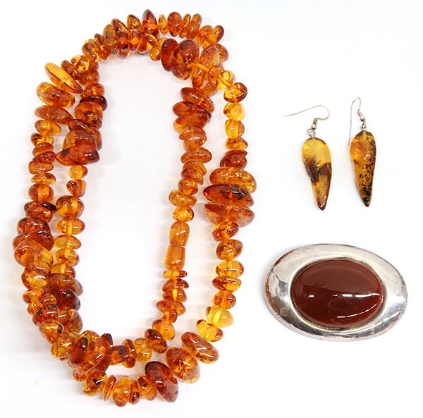 Collection of amber and carnelian jewelry: Collection of amber and carnelian jewelry including an amber necklace, 30 inches; A pair of amber and sterling silver earrings together with a large carnelian and sterling silver brooch