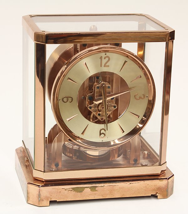 Le Coultre Atmos clock: Le Coultre Atmos clock, having a glass paneled case, the circular dial with Arabic numerals, and rising on a footed base, 9"h x 7.5"w x 6"d