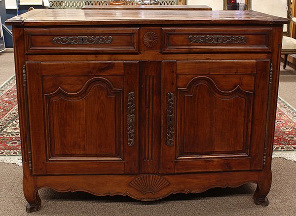 French Provincial style server: French Provincial style server, circa 1800, having a rectangular top surmounting the conforming case with two paneled drawers above two paneled doors, all with ornate pierced escutcheons, the whole ri