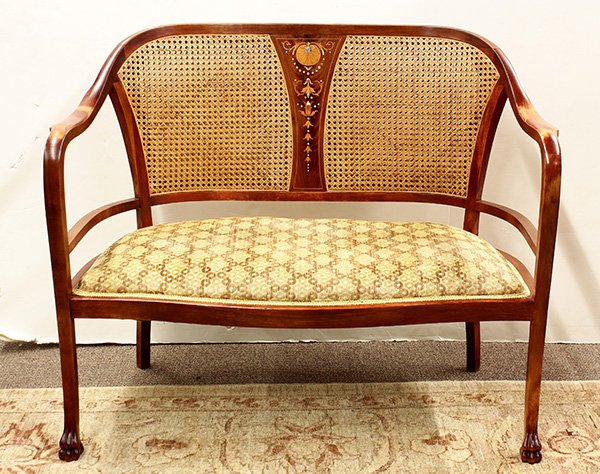Edwardian mother of pearl inlaid settee: Edwardian mother of pearl inlaid settee, having a cane back centered with a marquetry decorated frieze with bellflower accents, and rising on square legs terminating on stylized paw feet, 34"h x 41"w 