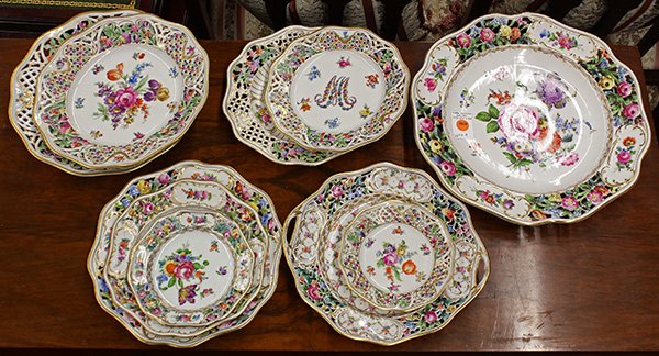 Dresden partial table service: (lot of 56) Dresden partial table service, each having a reticulated border and polychrome floral accents, consisting of (10) large dinner plates, 11.25"dia.; (10) luncheon plates, plus (4) additional