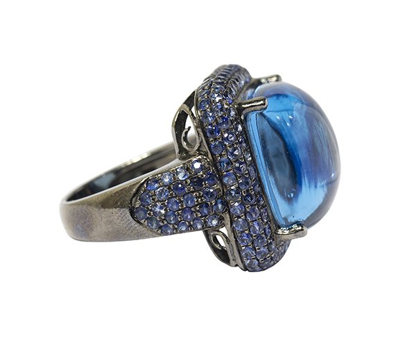 Blue topaz, sapphire and sterling silver ring: Blue topaz, sapphire and sterling silver ring featuring one sugar loaf cabochon blue topaz weighing approximately 20.00 cts., accented by numerous pave' set sapphires totaling approximately 2.45 cts.,