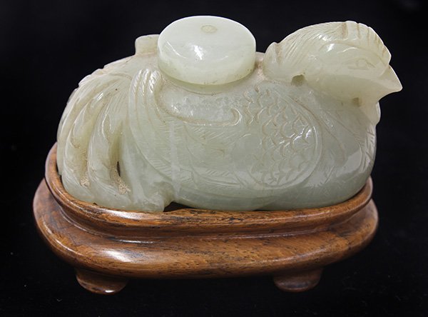 Chinese Bird Form Vessel: Chinese jade form vessel, in the form of a perched phoenix, the celadon matrix with light inclusions, together with a hardwood stopper, with wood stand, bird: 3.25"w