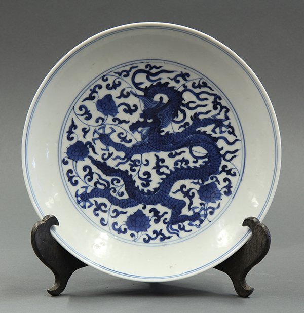 Chinese Blue and White Plate, Dragon: Chinese underglaze blue porcelain plate, with a meandering dragon amid flowering scrolls, the exterior decorated with two pairs of fu-lions, apocryphal Jiajing mark to base, 8.75"w