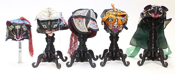 (lot of 5) Chinese Children's Silk Zoomorphic Hats: (lot of 5) Chinese children's silk zoomorphic hats with five hat stands, elaborately executed with appliques, satin stitches, couching and ink, 22"l
