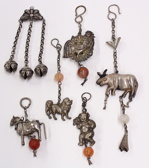 Group of Chinese Silver Toggles: (lot of 6) Chinese silver toggles, consisting of a child, rooster, butterfly, horse, fu-lion and a mythical beast, some with bells and carnelian beads, largest: 7.75"h