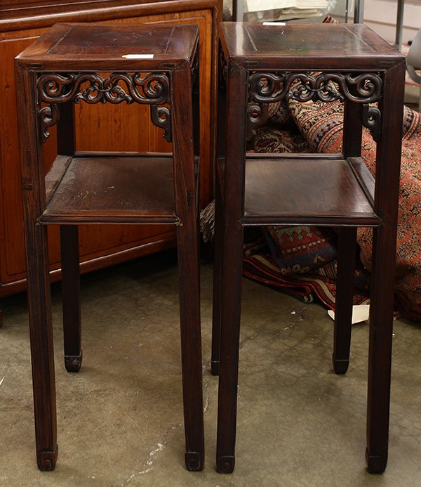 Two Chinese Hardwood Stands: Pair of Chinese tiered hardwood stands, each with a floating top panel within a plain edge, the apron pierced with scrolling tendrils, and above a second tier joined to the straight supports, 31.25"h