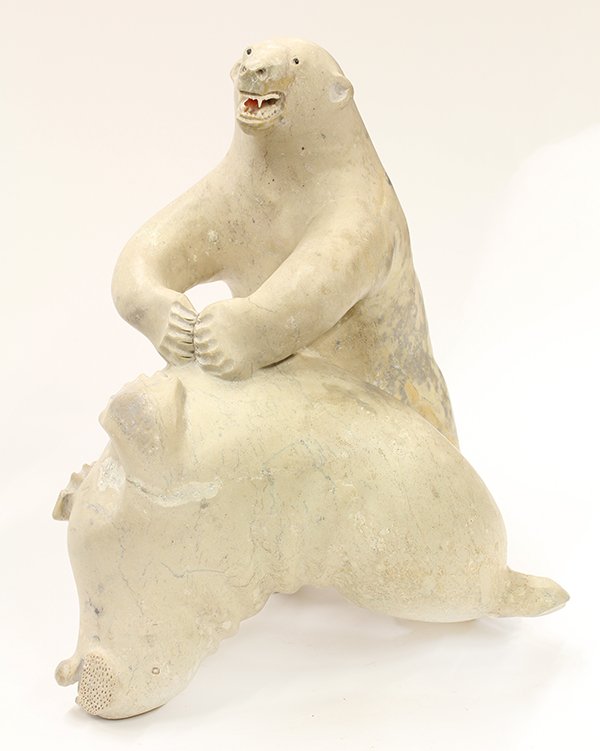 Monumental Inuit figural carving: Monumental Inuit figural carving, depicting a polar bear with jaws agape taking down a walrus, 14"h x 12"w x 10"d
