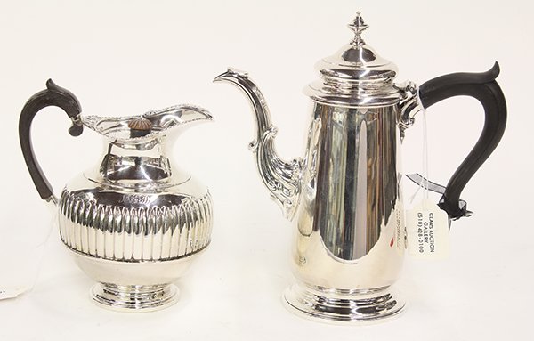 Sterling silver table articles: (lot of 2) Sterling silver table articles including a Georgian style milk jug, London, circa 1897, 6"h; and a Gebelein lidded coffee pot, having a scroll work handle and spout, 8.5"h, 26.99 troy oz.