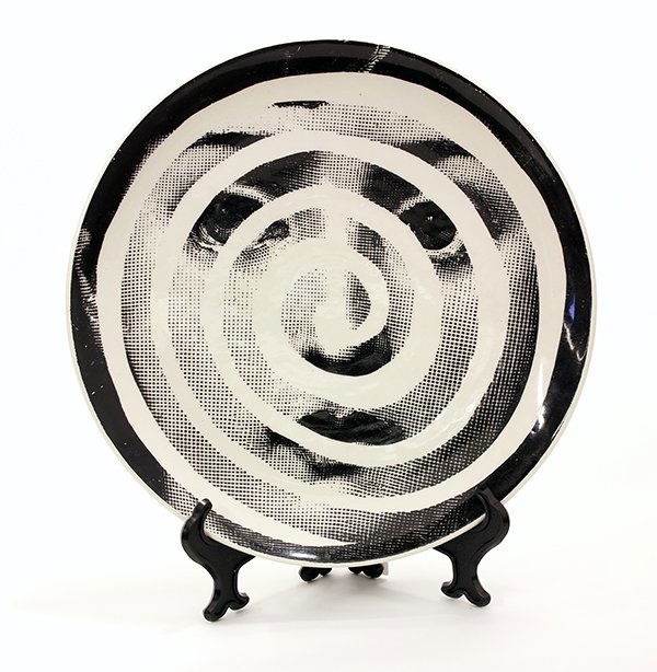 Fornasetti surrealist plate: Fornasetti surrealist plate, "Tema e Variazioni", depicting a face overlaid with a spiral, with Fornasetti mark and made in Italy, 10.5"dia