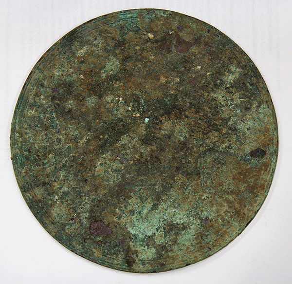 Bronze disk: Bronze disk, possibly from antiquity, having incised decoration, raised on an acrylic stand,7'dia
