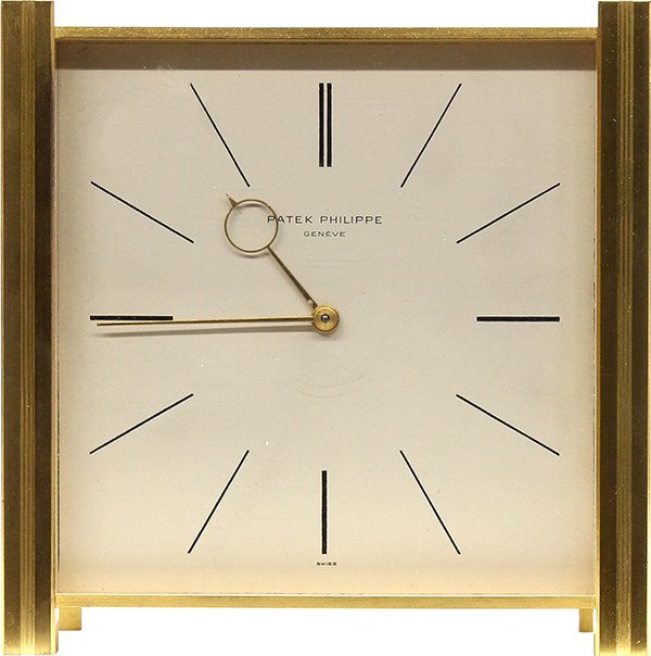 Swiss Patek Phillipe #1065 solar powered desk clock: Swiss Patek Phillipe #1065 solar powered desk clock, having a solar powered motor that drives a 29 jewel mechanical Patek Philippe movement fronted by the white dial, and housed in a gilt brass case,