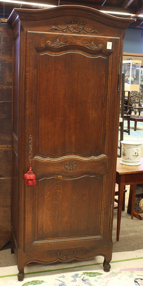 Louis XV style oak cabinet: Louis XV style oak cabinet, circa 1870, the shaped and molded top rising above a single panelled door having a central carved rosette, opening to reveal an open interior, and rising on stylized cabrio