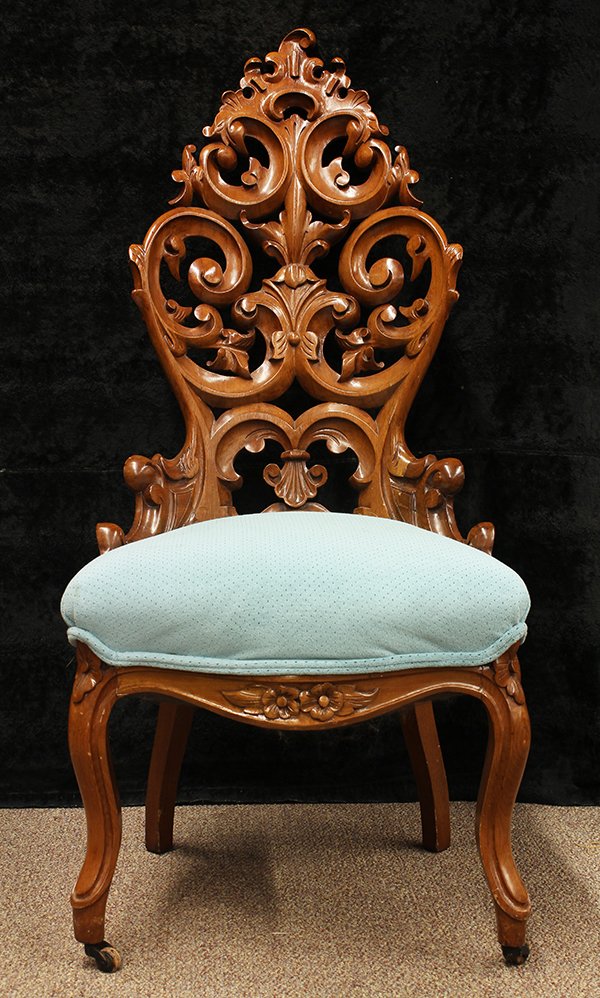 American Rococo Revival hall chair: American Rococo Revival hall chair, executed in walnut circa 1860, the high back accented with pierced floral and scroll detail continuing to the serpentine seat, and rising on cabriole legs, 42"h