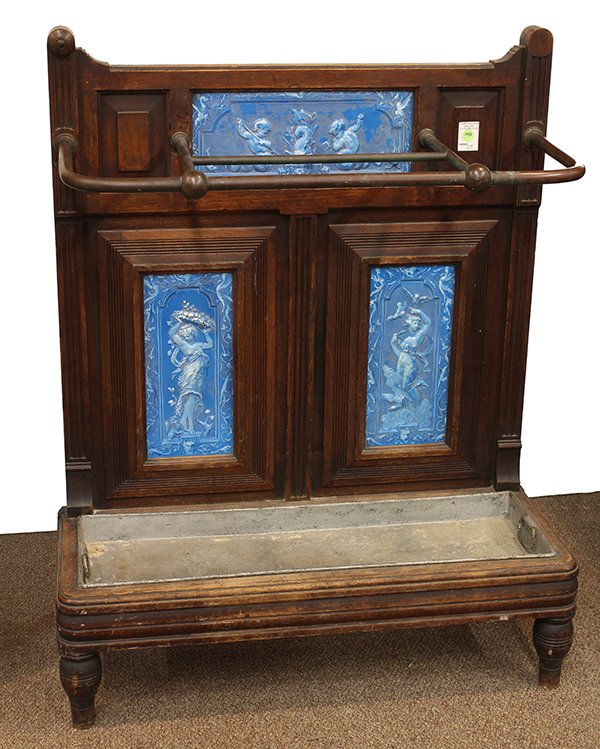 Victorian oak umbrella stand: Victorian oak umbrella stand, 19th century, the back with three inset tiles executed in azure and decorated with putti and nude beauties, surmounting the handled tin insert and rising on turned legs, 