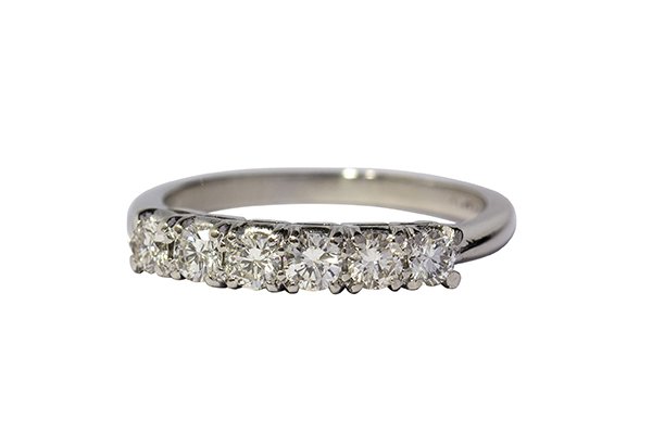 Diamond and platinum wedding band: Diamond and platinum wedding band comprised of a row of six full cut diamonds totaling approximately 0.60 ct., set in a band mounting, size 6 1/4, 4.4 grams