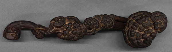 Chinese Wood Ruyi Scepter: Chinese wooden ruyi scepter, reputed to be chenxiangmu (aloeswood), the gnarled shaft accented with small lingzhi sprigs, 14.5"w