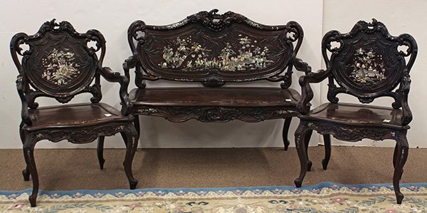 Chinese/Vietnamese Rococo-style Export Suite: (lot of 3) Chinese/Vietnamese export mother-of-pearl inlaid sitting room suite, consisting of a Rococo-style settee and a pair of armchairs, the back panel with a mother-of-pearl inlaid procession thr